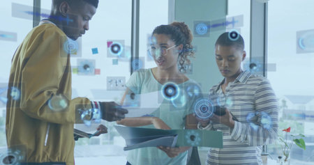 Reviewing three colleagues examining documents and phone at office, with AR graphics and red flower. Teamwork, collaboration, workspace, technology, urban, naturallight, overlayの写真素材