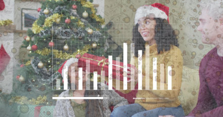 Passing man handing red gift to woman in Santa hat, mustard sweater, livingroom tree. Pine, family, festive, photography, photoreal, interiorの写真素材