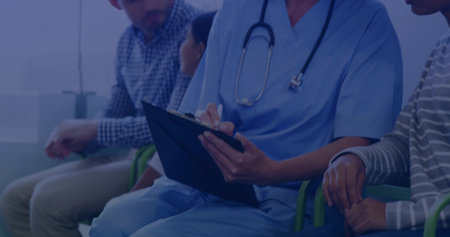 Writing medical professional in blue scrubs filling clipboard with pen in clinic, with stethoscope....