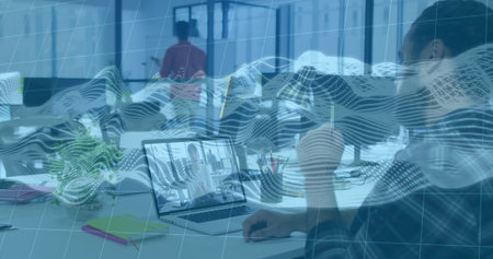 Holding cup, woman dark top viewing laptop caller at office plant notebooks waveform, copy space. Desk, workspace, business, minimal, technology, daylight, gridの写真素材