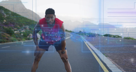 Pausing runner in red sleeveless top, black shorts on coastal road, with HUD overlay and wristwatch. Endurance, training, outdoors, seaside, mist, augmented, realityの写真素材
