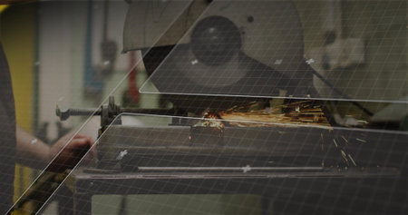 Operating man in work shirt cutting metal bar with cut-off saw at workshop bench, sparks, clamp....