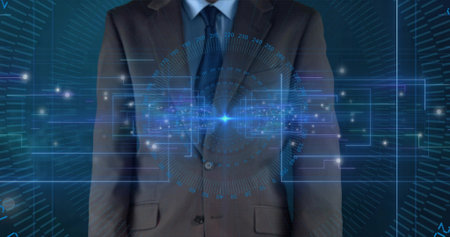 Showing adult male torso wearing dark suit and blue tie in studio, projecting holographic HUD node. Digital, interface, data, executive, corporate, futuristic, cyanの写真素材