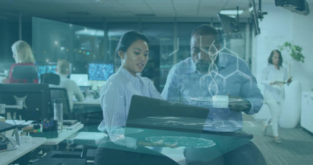 Presenting striped-top woman and blue-shirt colleague reviewing laptop at open office with AR. Collaboration, analytics, data, teamwork, workspace, modern, augmentedの写真素材