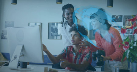 Collaborating seated man in red plaid shirt editing on desktop computer at studio, with DSLR camera. Teamwork, design, workspace, modern, technology, globe, deskの写真素材
