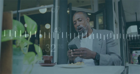Holding man in gray blazer and tee checking smartphone at cafe, with cup plant, data overlay. Urban,...
