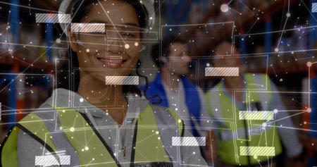 Smiling woman warehouse worker in hi-vis vest and headset checking stock on racks, with AR overlay. Industrial, logistics, teamwork, collaboration, safety, digital, visualizationの写真素材
