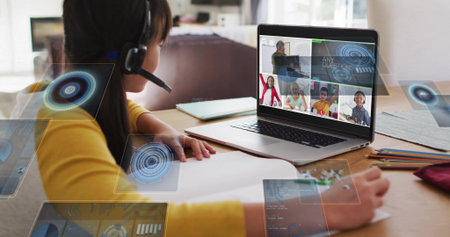 Taking notes child wearing yellow top and headset at home desk, with notebook and laptop overlays....