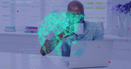 Sipping man wearing blue polo holding white mug at home desk with silver laptop, holographic globe....