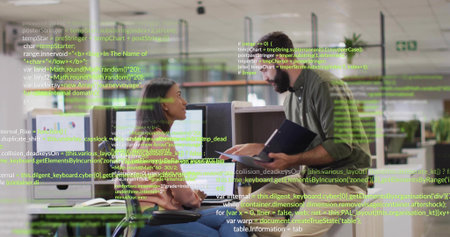 Pointing at monitors, two team members in casual clothes holding tablet in open office code overlay. Collaboration, software, development, visualization, coworking, professional, modernの写真素材