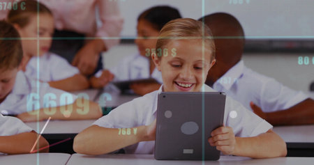Smiling girl holding vertical tablet at school desk, teacher wearing suit watching numeric overlay....