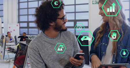 Talking coworkers in gray sweater and denim jacket with phone and tablet in office, green overlays....