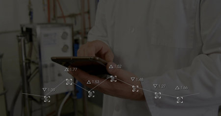 Tapping tablet, lab technician in white lab coat monitoring data overlay in lab with tanks. Handheld, touchscreen, graph, analytics, industrial, facility, instrumentationの写真素材