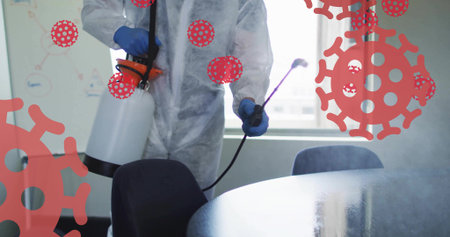 Spraying man in coverall blue gloves misting meeting room with handheld sprayer, red virus overlays....
