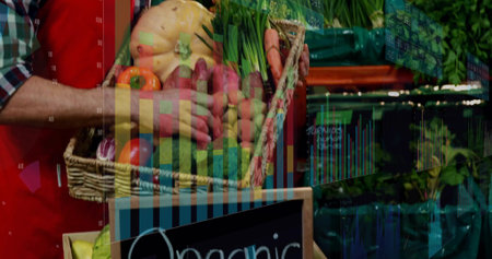 Holding man wearing red apron plaid shirt woven produce basket at market, Organic chalk sign charts. Vegetables, vendor, display, rustic, vibrant, local, retailの写真素材