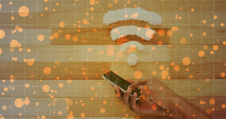Holding right-hand-forearm in dark sleeve, tapping phone on wood wall with Wi-Fi orange-coin grid....