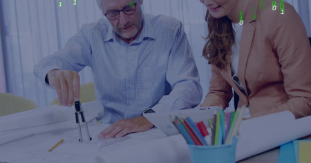 Examining senior man and woman in blazer studying large plans at office, using compass and tablet....