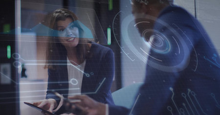 Leading meeting, woman navy blazer holding tablet at office, HUD overlay, colleague holding phone....