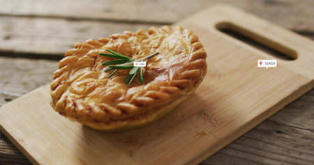 Displaying round pie featuring braided crust and rosemary on cutting board with handle, label icons....