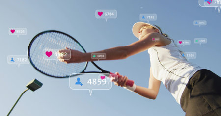 Swinging tennis player holding racket on court wearing visor and tank top. Outdoor, athletic, female, sportswear, action, motion, dynamicの写真素材