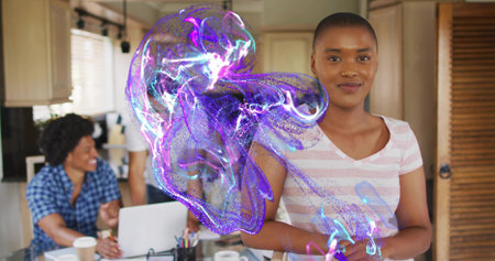 Standing woman in pink-tee clasping in kitchen with laptop, mugs and purple hologram, copy space....