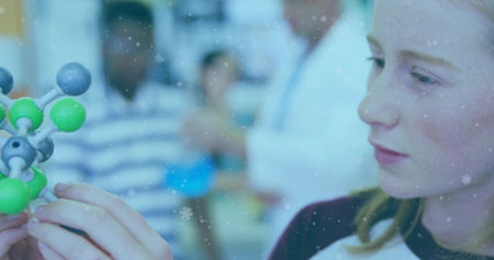 Studying teen wearing dark collar holding molecular model in lab with teacher lab coat, copy space. Student, classroom, chemistry, molecule, collaboration, instructor, laboratoryの写真素材