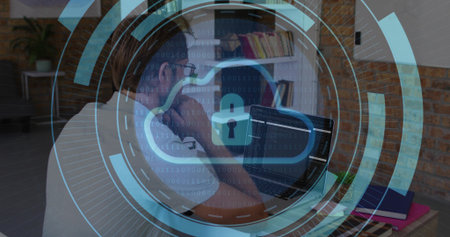 Working mid-adult man wearing glasses typing code on laptop in home office, with cloud lock overlay....