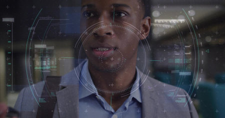 Scanning mid-adult man in gray blazer, blue shirt viewing AR HUD at terminal, shoulder bag. Augmented, reality, overlay, commuter, professional, concourse, futuristicの写真素材