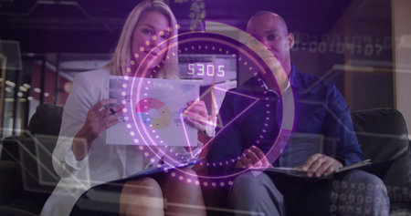 Presenting partners in business clothes pointing at pie chart in office lounge viewing hologram. Collaboration, data, visualization, overlay, workspace, modern, professionalsの写真素材