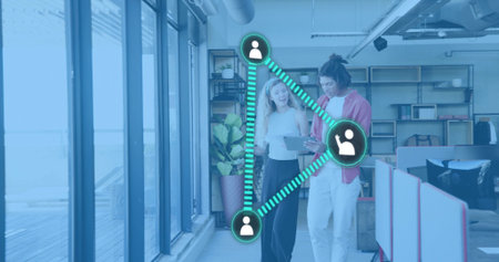 Walking woman in white top, man in red shirt viewing tablet at office, showing teal network....