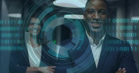 Standing man in suit crossing arms and smiling in modern office corridor, with AR HUD. Augmentedreality, holographic, binary, teal, partition, reflections, collaborationの写真素材