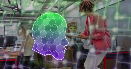 Leaning man in pink shirt holding tablet for seated coworker in open office, neon honeycomb overlay....