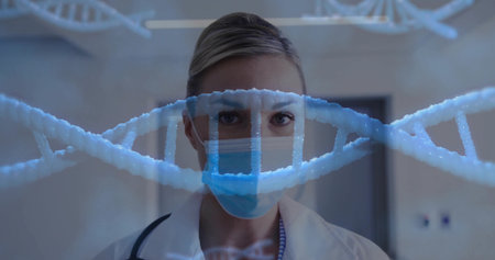 Standing female doctor facing camera in clinic, wearing mask, white coat, stethoscope DNA helix....