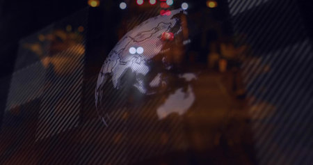 Hovering translucent globe projection over urban night street, showing continent outlines and bokeh....