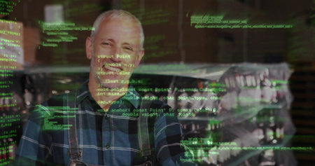 Mature man in plaid shirt smiling, crossing arms in shop with wrapped pallets, green code overlay. Technician, warehouse, industrial, gear, storage, digital, glowの写真素材