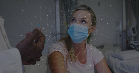 Looking up, patient wearing pink shirt, blue mask on hospital bed with doctor hand, network overlay....