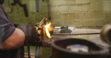 Operating cutting torch, welder in thick gloves cutting metal on bench, sparks, copy space....