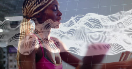 Gripping woman with braids pushing machine handles in gym, wearing pink top and waveform overlay. Fitness, cardio, athlete, activewear, augmented, reality, biometricの写真素材