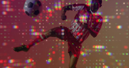 Kicking adult player doing high side kick in studio with pixel lights, striped kit, soccer ball....