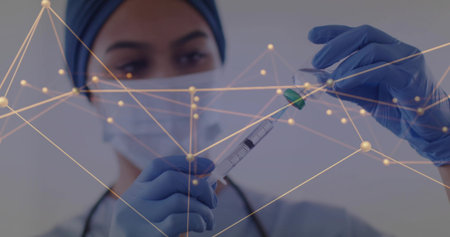 Inspecting nurse drawing medication into syringe at clinic, mask, gloves, hijab, data overlay. Clinician, needle, medical, healthcare, injection, sterile, digitalの写真素材