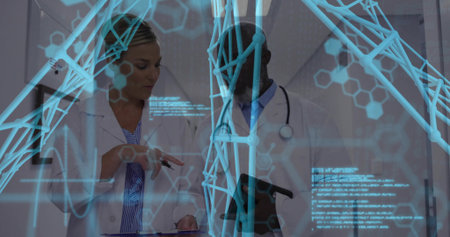 Gesturing physician and colleague studying tablet in clinic, wearing lab coats, showing AR overlay. Holographic, molecular, hexagonal, lattice, collaboration, diagnostics, laboratoryの写真素材