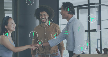 Shaking hands three staff in business attire greeting in office, with energy and finance icons. Collaboration, teamwork, handshake, partnership, sustainability, workspace, openplanの写真素材