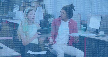 Discussing, white-top woman and red-jacket man with phone and papers in office lounge, data overlay. Collaboration, discussion, openplan, cybersecurity, digital, monitors, coffeeの写真素材