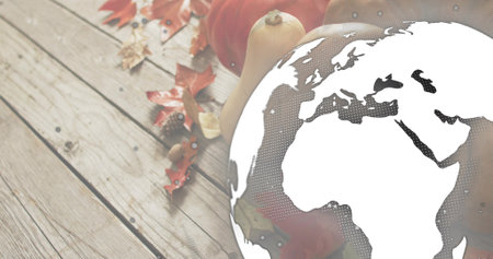 Overlaying globe graphic halftoning Europe Africa over wooden tabletop with pumpkins squash leaves. Flatlay, harvest, rustic, autumn, plank, butternut, mapleの写真素材
