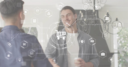 Shaking man in foyer wearing light tee open longsleeve shirt, holding cup. Professional, networking, greeting, interior, daylightの写真素材