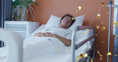 Lying mature woman resting on hospital bed at ward, wearing hospital gown, showing IV line. Patient, recovery, clinical, serene, calm, intravenous, tubingの写真素材