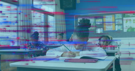 Writing child student in white long-sleeve top leaning over front desk in classroom, with notebook. Daylight, posters, monitor, school, learning, focus, concentrationの写真素材