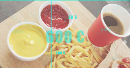 Displaying fries on wooden board at counter with sauces red cup wrapped sandwich turquoise overlay. Chips, platter, condiments, wrapper, texturedの写真素材