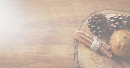 Showing rustic wood slice on right table with cones, twine-tied cinnamon stick, cookie, copy space. Pinecones, muffin, spice, bundle, crosssection, tabletop, grainの写真素材