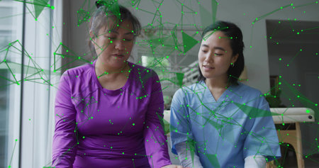 Sitting patient in purple and clinician in blue scrubs at clinic couch, showing green AR network....